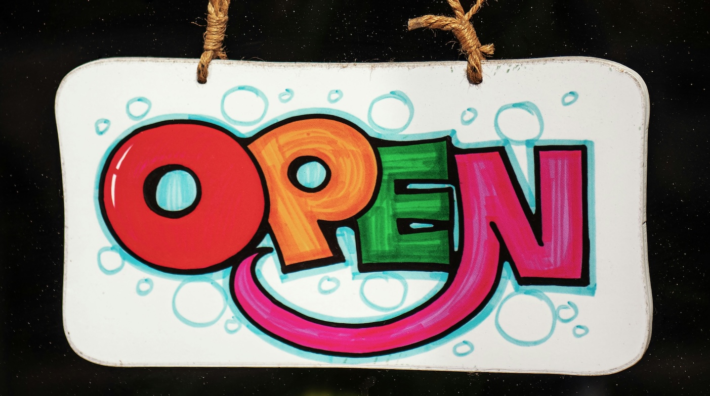 Brightly coloured "open" shop sign in bubble type. Highlighting The Top 5 Issues Small Business Owners Face and how resilient they are.